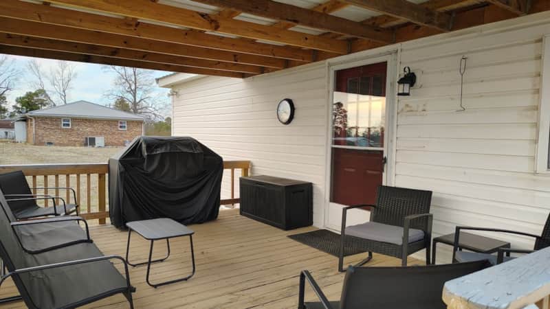Covered back deck and patio at Lichner Resort Stays with outdoor seating and grill